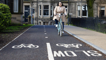 A lady cycling on a segregated cycle path