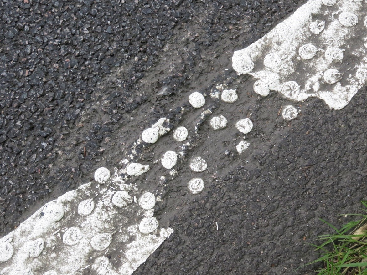 Mechanical damage to surface course at site IP28, as described in text above.
