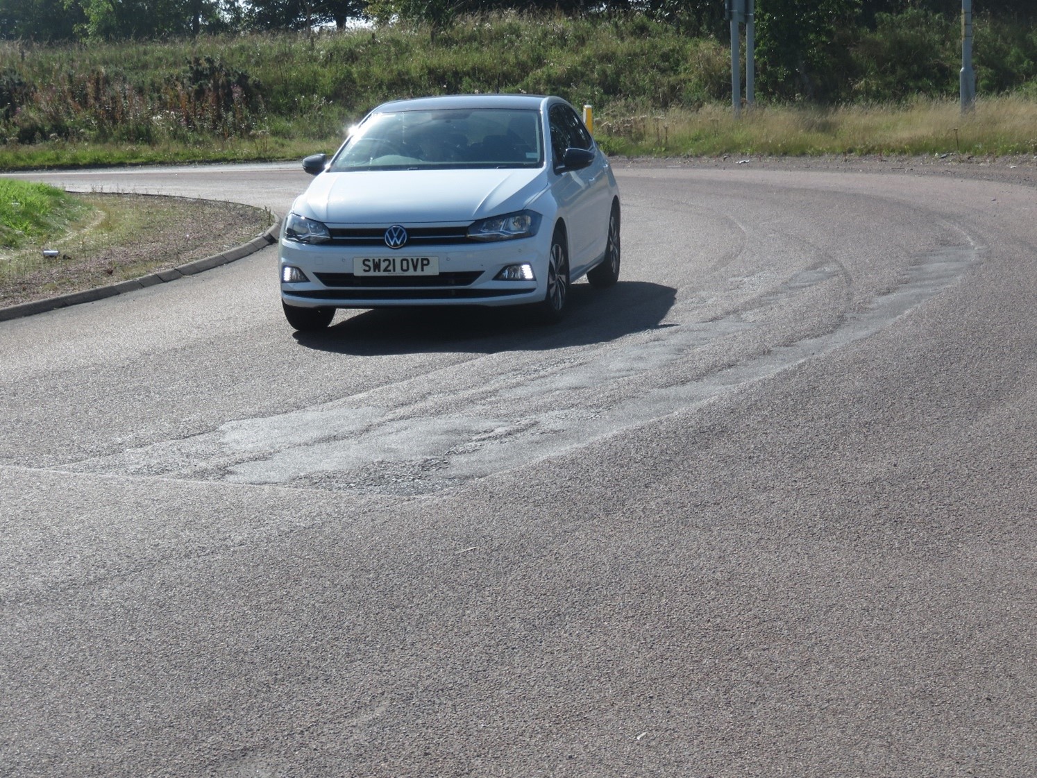 Car on a roundabout at site IP40b, showing surfacing failure as described in text below.